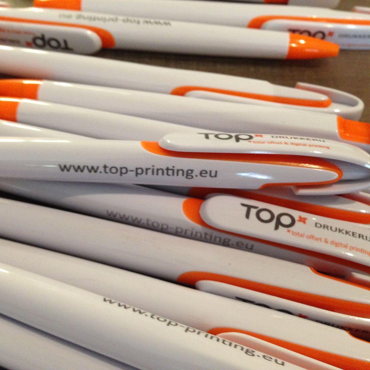 Branded white orange pen
